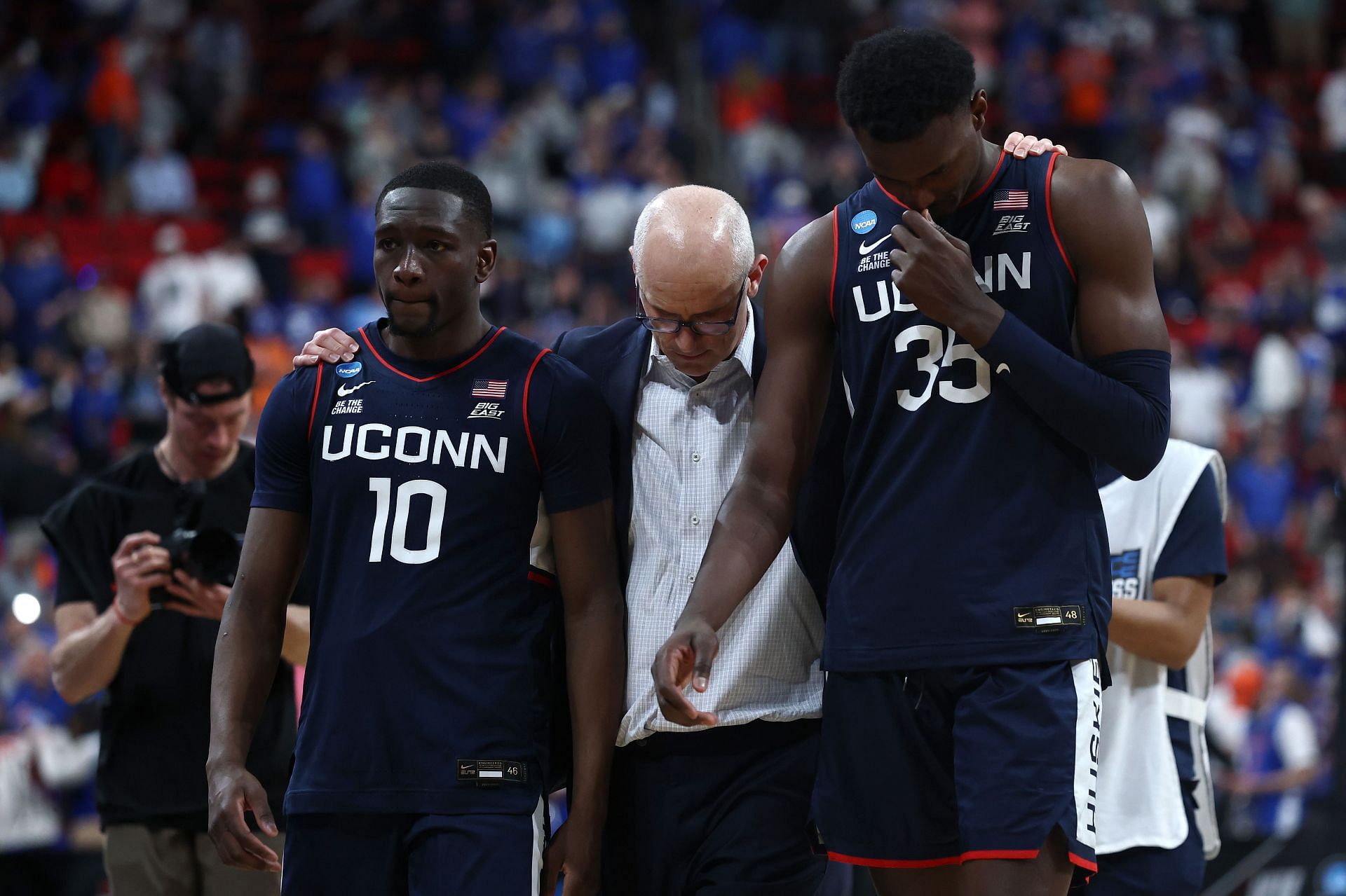 Head coach Dan Hurley of the UConn Huskies walks off the court with Hassan Diarra (#10) and Samson Johnson (#35) after losing to the Florida Gators 77-75 in the second round of the 2025 NCAA Men's Basketball Tournament at Lenovo Center. Photo: Getty